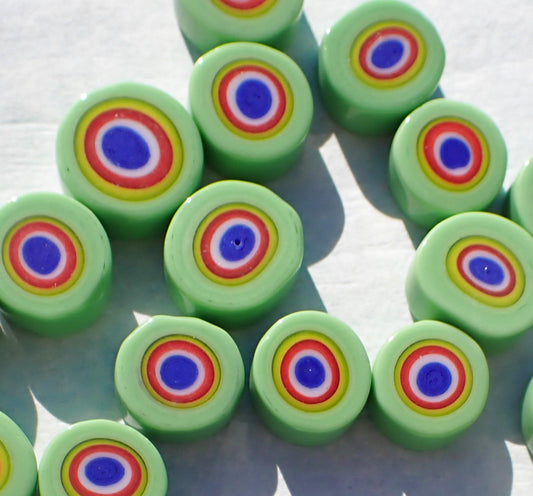 Green millefiori with colorful bullseye pattern.
